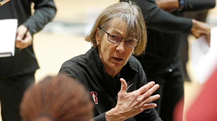 Stanford head coach Tara VanDerveer instructs her team between quarters during an NCAA college basketball game.
